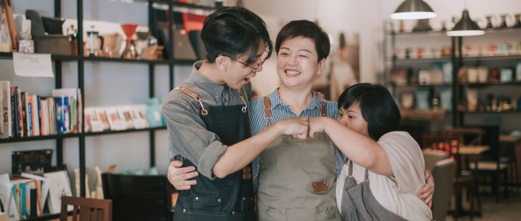 three workers hugging