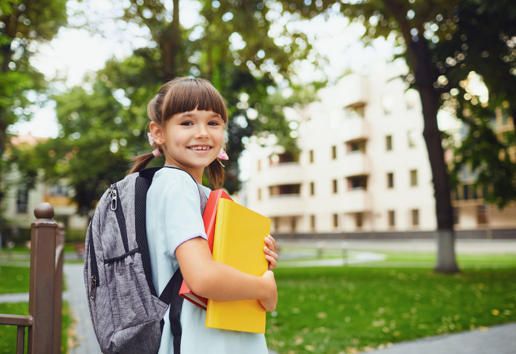 little girl holding books